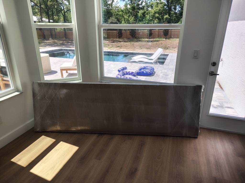 New exterior door slab delivered in protective wrap for pet door installation