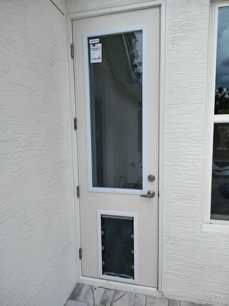 New exterior door with a pre-installed dog door on an Austin TX home