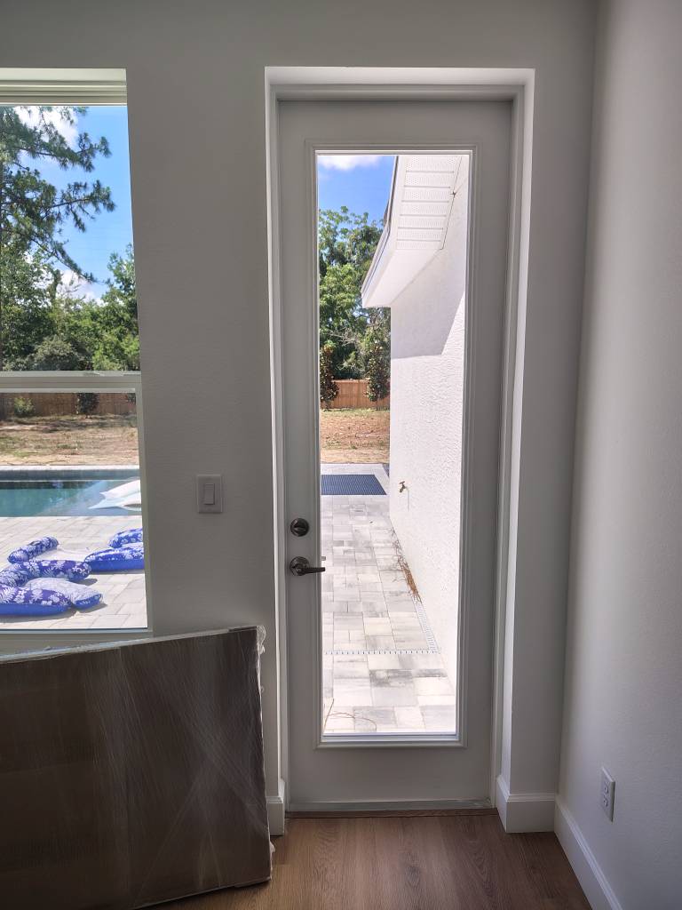 Original full glass exterior door before pre-installed pet door replacement